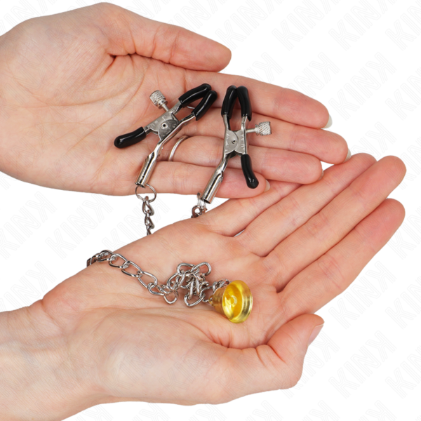 Two Kink Nipple Grip nipple clamps joined by a chain with a gold bell